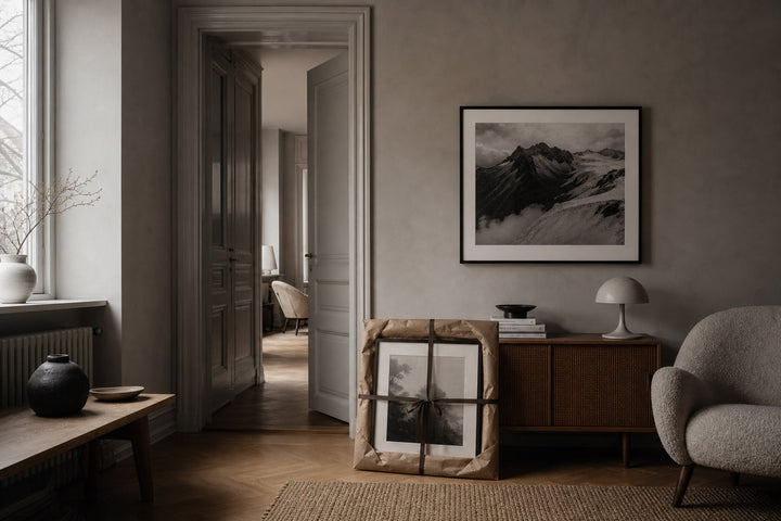Nordic editorial quiet Nordic entry or living room featuring beautifully wrapped framed art presented as a thoughtful gift beside a finished interior vignette