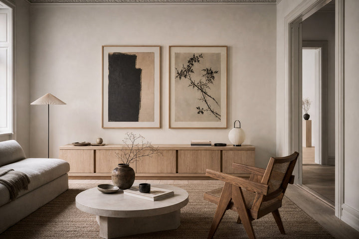 Nordic editorial refined Nordic living room featuring carefully composed framed-art vignette that directly illustrates the article subject