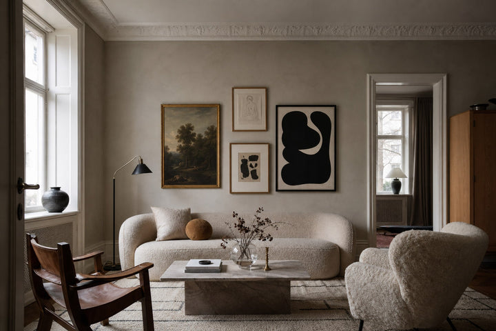 Nordic editorial refined Nordic living room featuring carefully composed framed-art vignette that directly illustrates the article subject