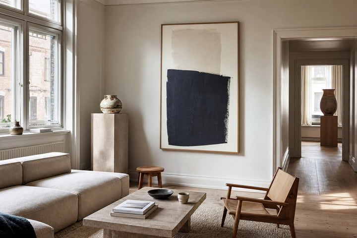 Nordic editorial well-proportioned Nordic living room featuring correctly scaled framed art demonstrating the format and placement described by the article