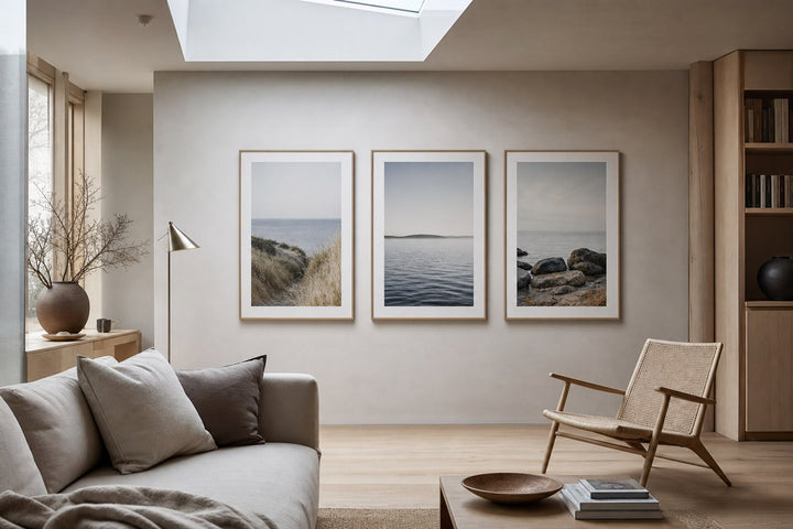 Nordic editorial Nordic coastal or travel-inspired sitting room featuring framed art that evokes place, horizon and travel memories