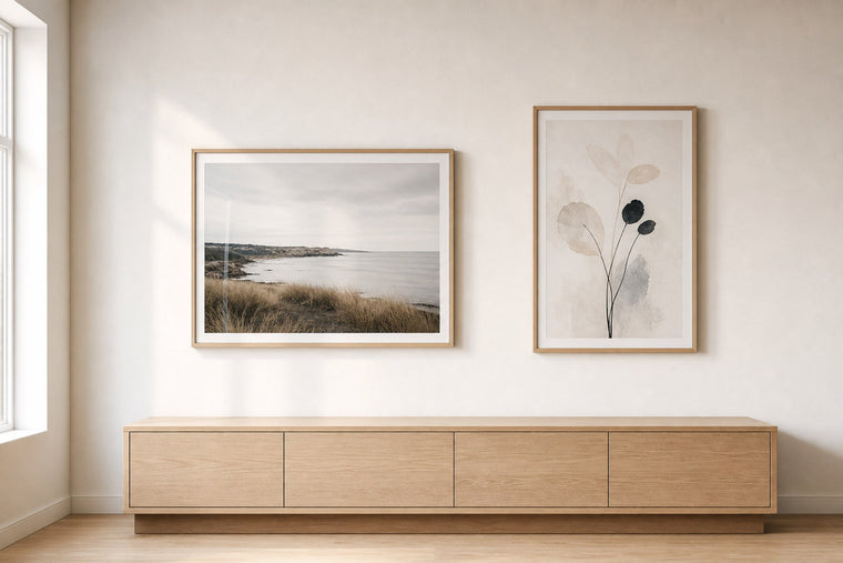 Nordic editorial Nordic coastal or travel-inspired sitting room featuring framed art that evokes place, horizon and travel memories