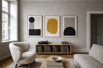 Nordic editorial refined Nordic living room featuring carefully composed framed-art vignette that directly illustrates the article subject