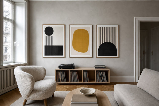 Nordic editorial refined Nordic living room featuring carefully composed framed-art vignette that directly illustrates the article subject
