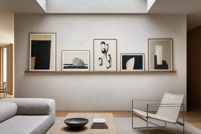 Nordic editorial refined Nordic living room featuring carefully composed framed-art vignette that directly illustrates the article subject