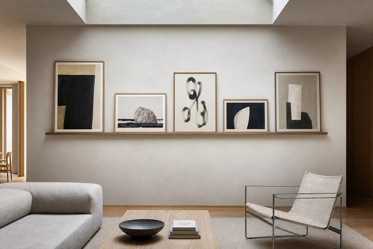 Nordic editorial refined Nordic living room featuring carefully composed framed-art vignette that directly illustrates the article subject