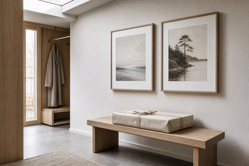 Nordic editorial quiet Nordic entry or living room featuring beautifully wrapped framed art presented as a thoughtful gift beside a finished interior vignette