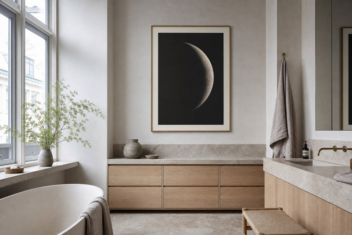 Nordic editorial spa-like Nordic bathroom featuring calming framed art placed on a dry wall above pale stone and oak cabinetry