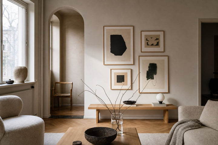 Nordic editorial refined Nordic living room featuring carefully composed framed-art vignette that directly illustrates the article subject