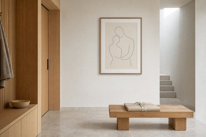 Nordic editorial quiet Nordic entry or living room featuring beautifully wrapped framed art presented as a thoughtful gift beside a finished interior vignette